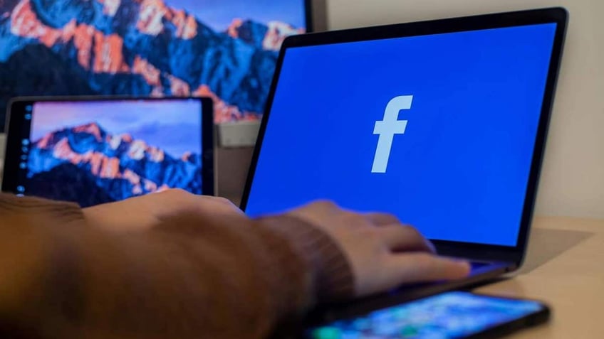 A person using Facebook on their laptop.