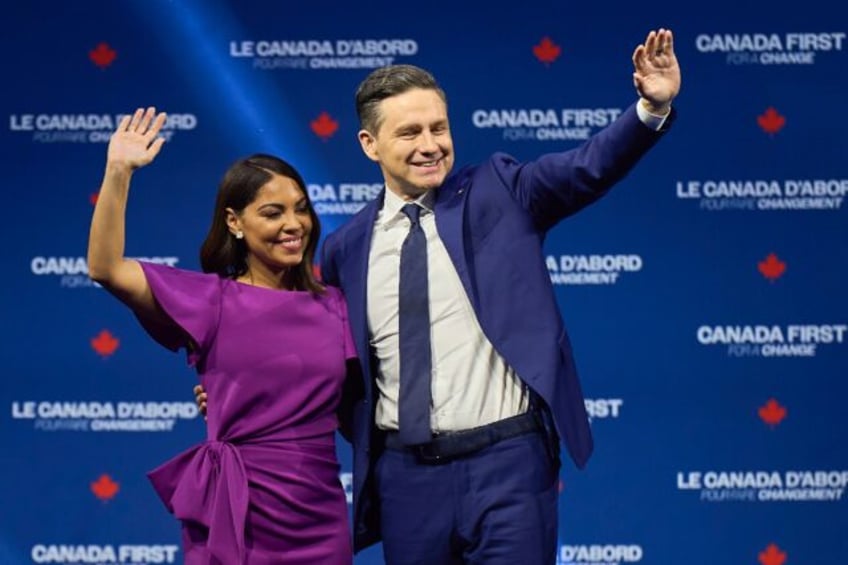 Canada's Conservative leader Pierre Poilievre (R) and his wife Anaida wave to supporters a
