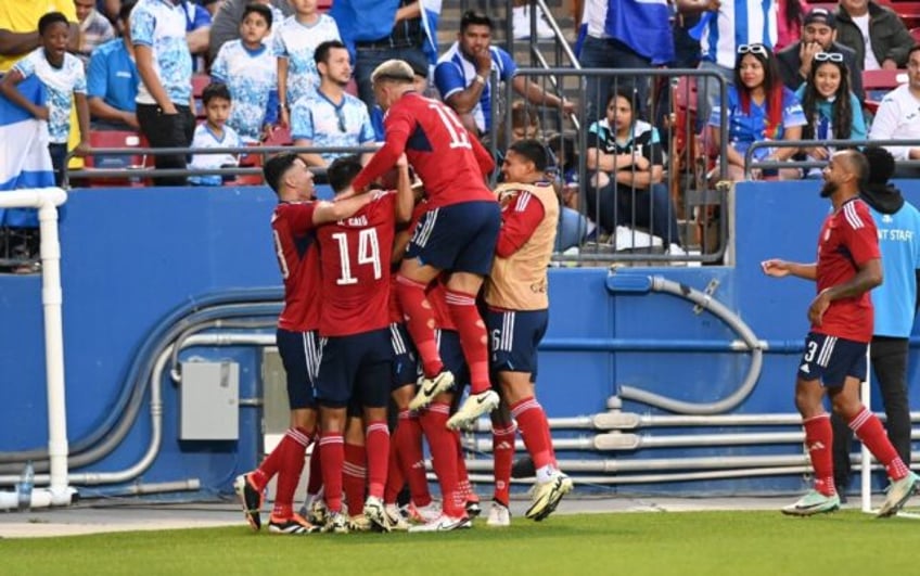 Costa Rica's players celebrate during their playoff win over Honduras to reach the Copa Am