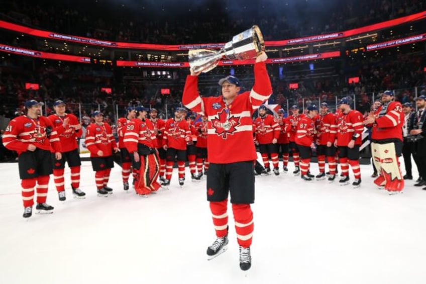 Tournament Most Valuable Player and goals leader Nathan MacKinnon of Team Canada holds the