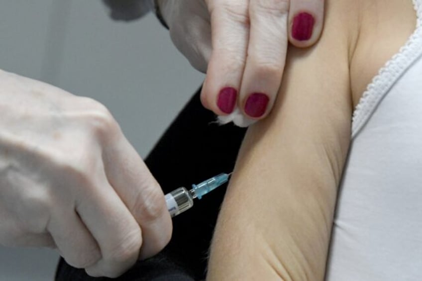 A health worker administers a measles vaccine