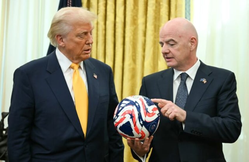 FIFA president Gianni Infantino (R) presents US President Donald Trump with the new FIFA C