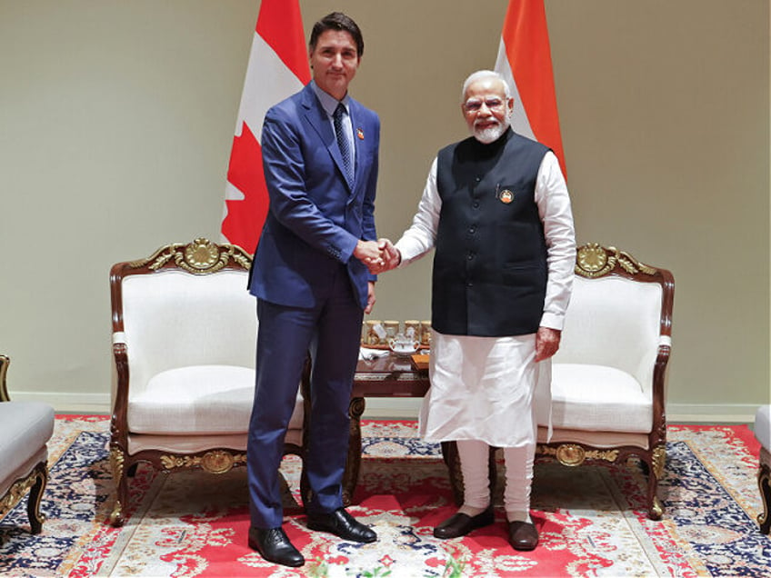 India's Prime Minister Narendra Modi (R) and his Canada counterpart Justin Trudeau shake h