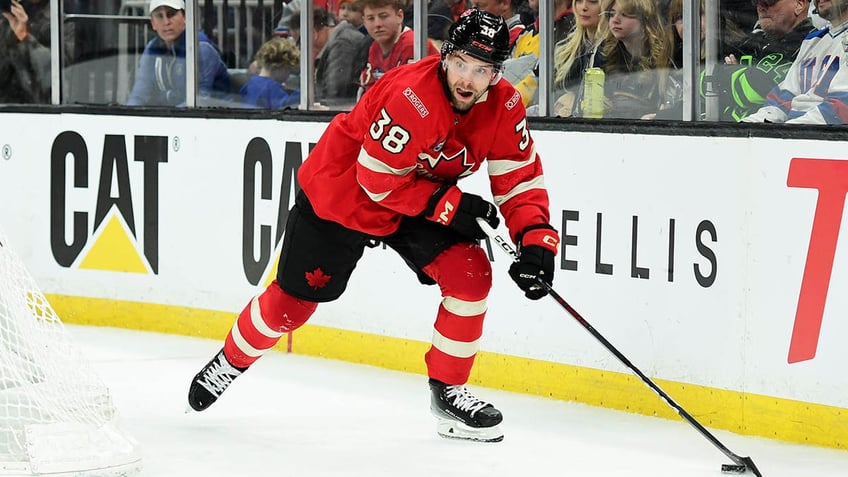 Brandon Hagel skates with puck