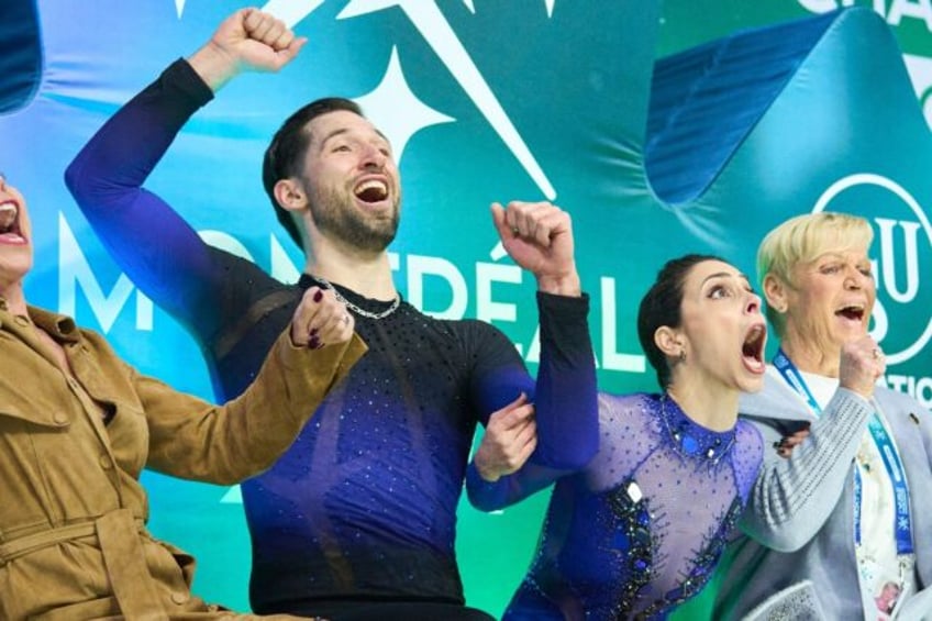 Deanna Stellato-Dudek and Maxime Deschamps of Canada celebrate after topping the short pro