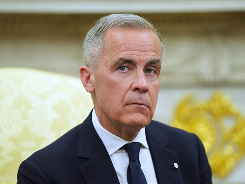 Canadian Prime Minister Mark Carney listtens to questions during a meeting with President