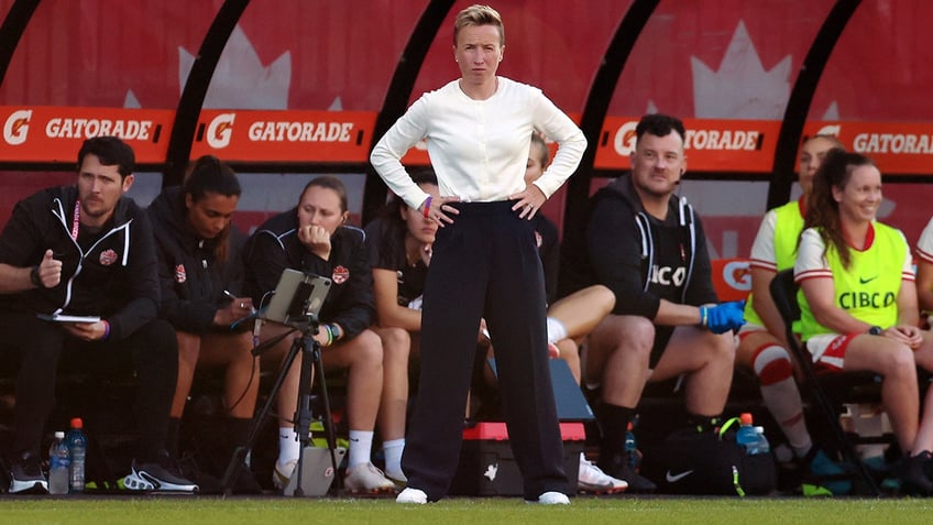 Bev Priestman looks on field