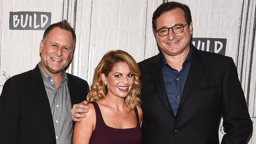 Dave Coulier and Candace Cameron Bure pose with the now-late Bob Saget.