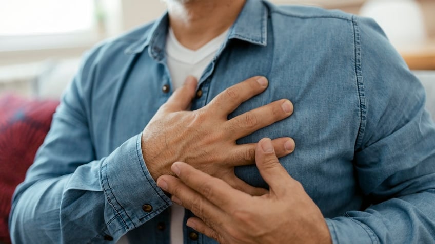 Man holding chest