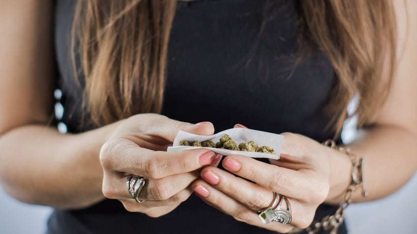 A marijuana joint being hand rolled close up 