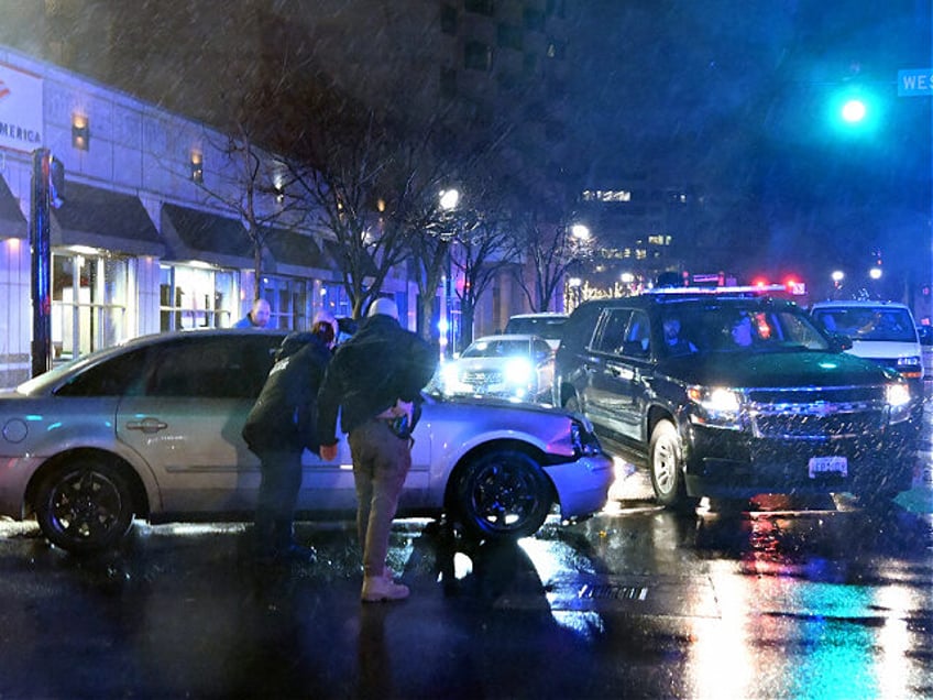 Members of the US Secret Service rush to a car, after it hit a motorcade SUV, as US president Joe Biden was leaving his campaign headquarters in Wilmington, Delaware on December 17, 2023. (Photo by ANDREW CABALLERO-REYNOLDS / AFP) (Photo by ANDREW CABALLERO-REYNOLDS/AFP via Getty Images)