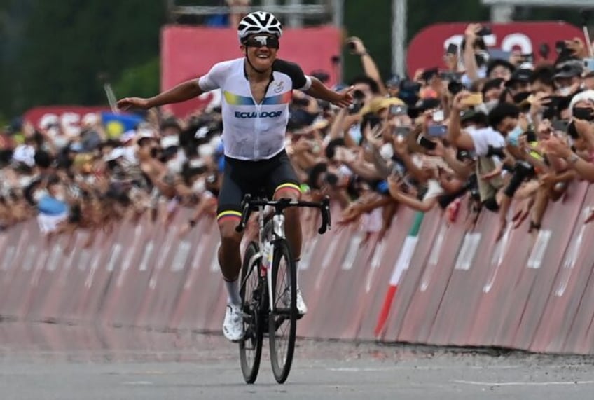 Ecuador's Richard Carapaz celebrates after taking gold in the men's cycling road race at t