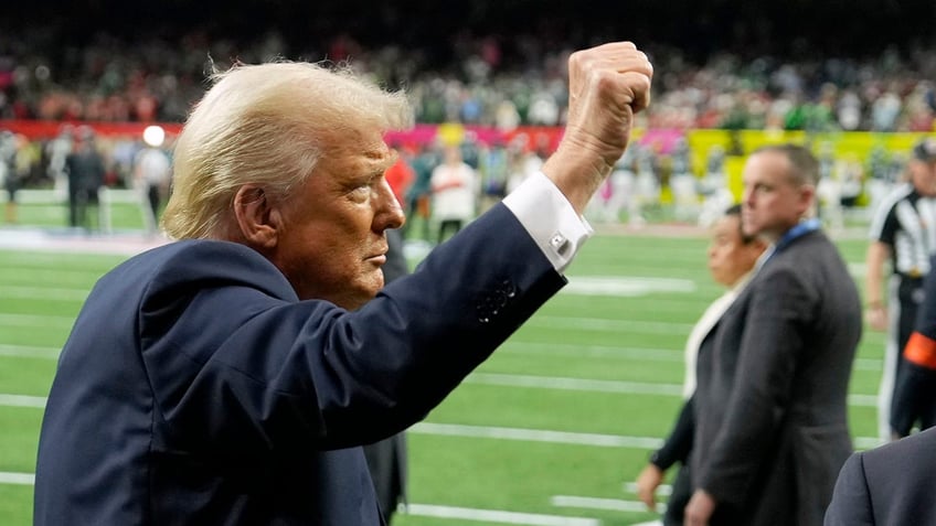 Donald Trump gestures to crowd