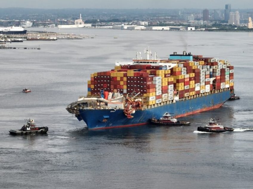 Tug boats maneuver the damaged container ship Dali into the Seagirt Marine Terminal in Bal