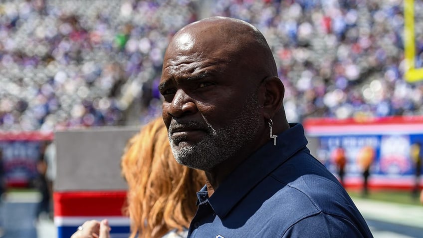 Lawrence Taylor looks on field