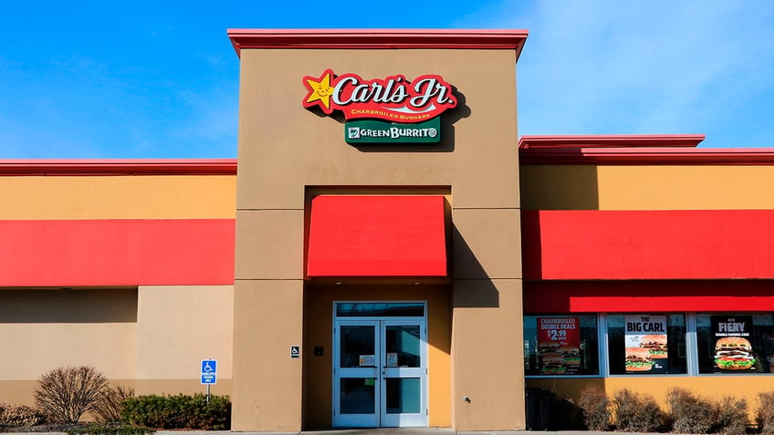 Carl’s Jr restaurant with company sign and logo above entrance,