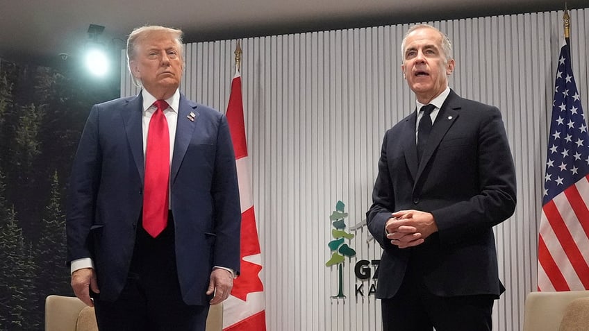 Carney speaks to reporters at G-7 as Trump listens