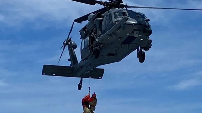 Mother and child lifted into chopper