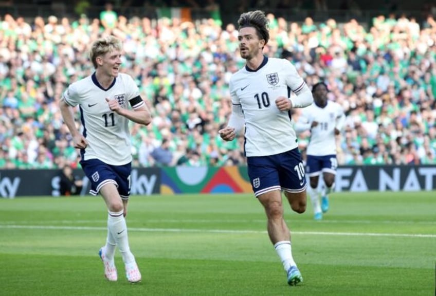 England's Jack Grealish (R) celebrates scoring against Ireland