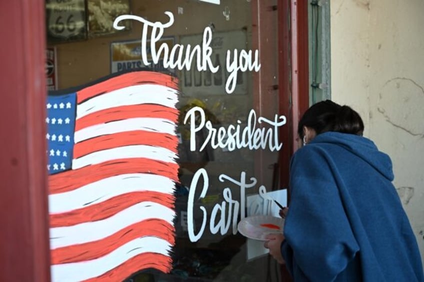 A mural in memory of Jimmy Carter is painted on a storefront at the Jimmy Carter National