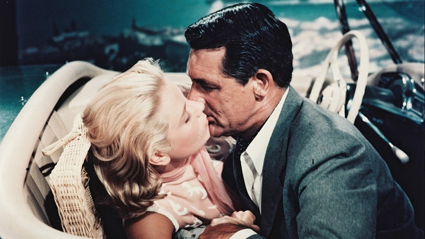 Grace Kelly kissing Cary Grant in a scene from a film