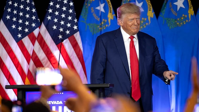 Trump in front of flags