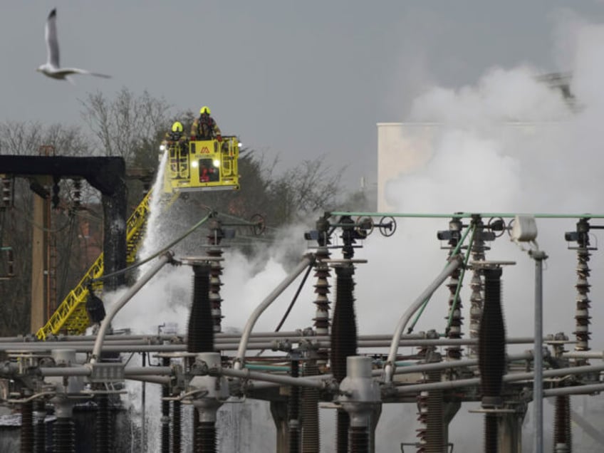 Firefighters extinguish the fire at the North Hyde electrical substation, which caught fir