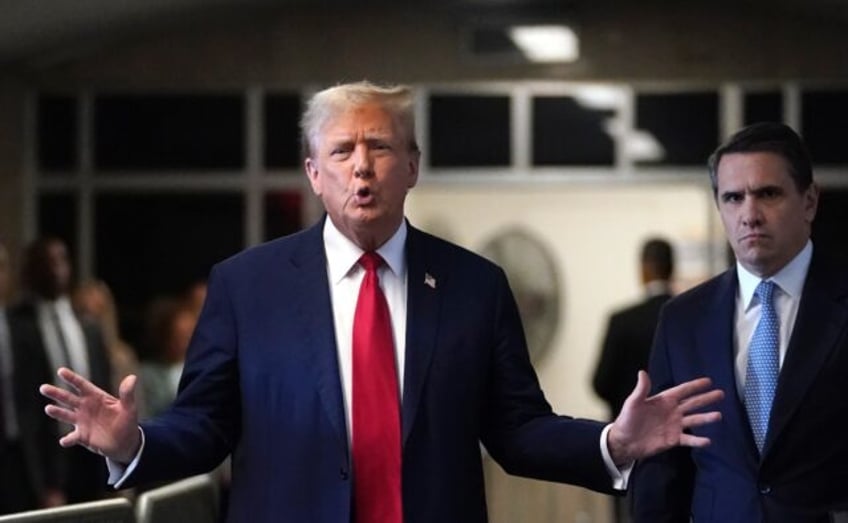 Former US President Donald Trump, with lawyer Todd Blanche (R), speaks to the press as he