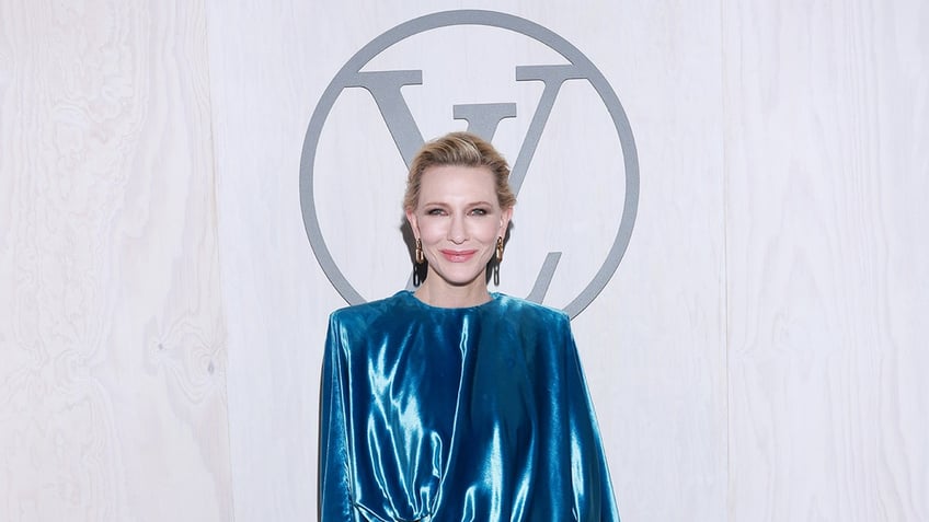 Cate Blanchett in a blue metallic shiny shirt at a Louis Vuitton event