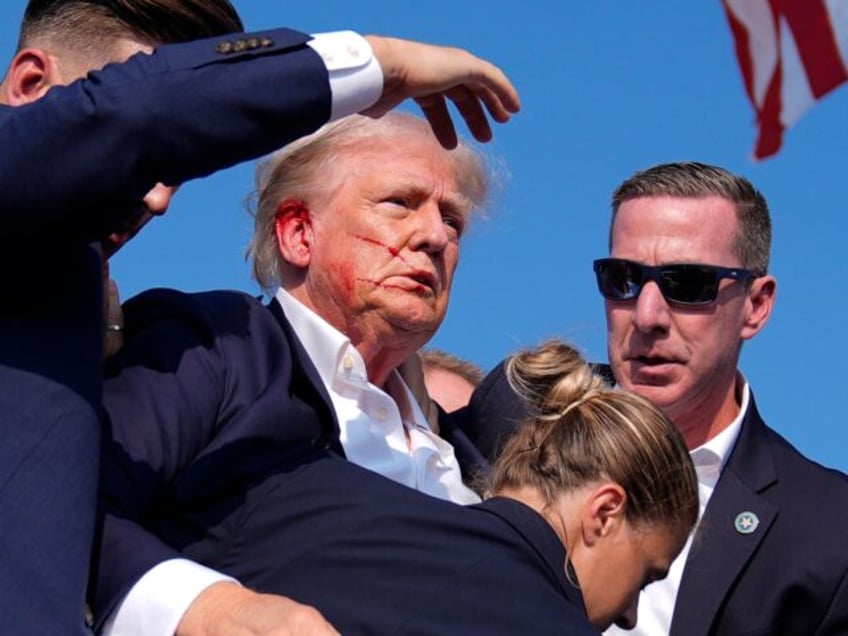 Republican presidential candidate former President Donald Trump is surrounded by U.S. Secr