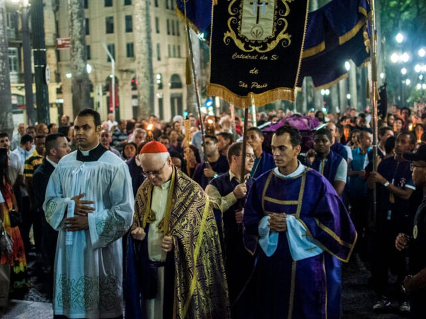 Penitents participate in the Procession of the Dead Lord at the Metropolitan Cathedral on