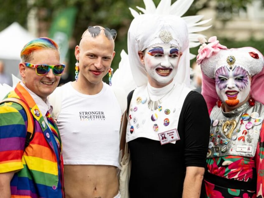 22 July 2023, Berlin: Visitors (l) to the CSD and queer activists from the Sisters of Perp