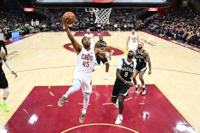 Donovan Mitchell of the Cleveland Cavaliers shoots over Bobby Portis in the Cavs' NBA vict