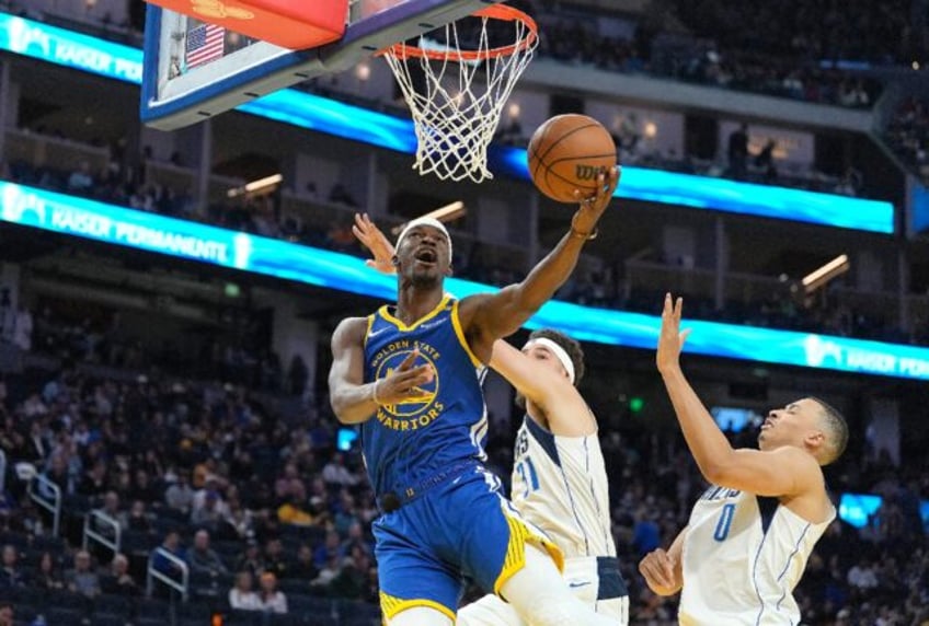 Golden State's Jimmy Butler flies to the basket in the Warriors' NBA victory over the Dall