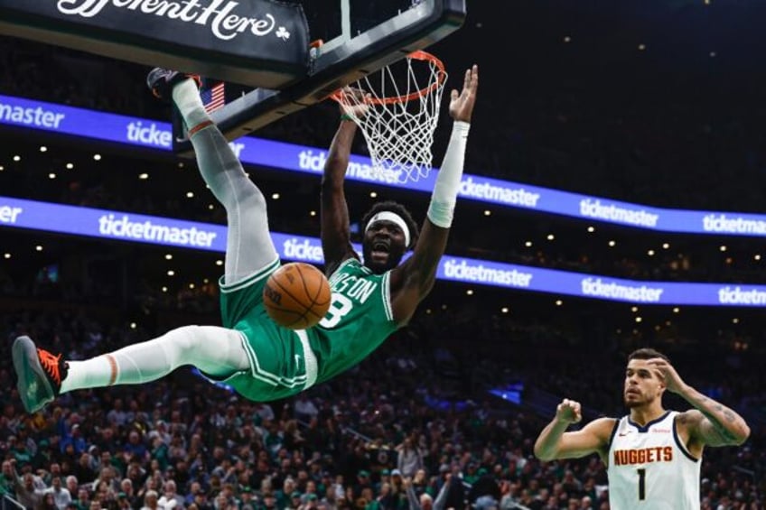 Boston's Neemias Queta screams out after dunking as Michael Porter Jr. looks on in the Cel