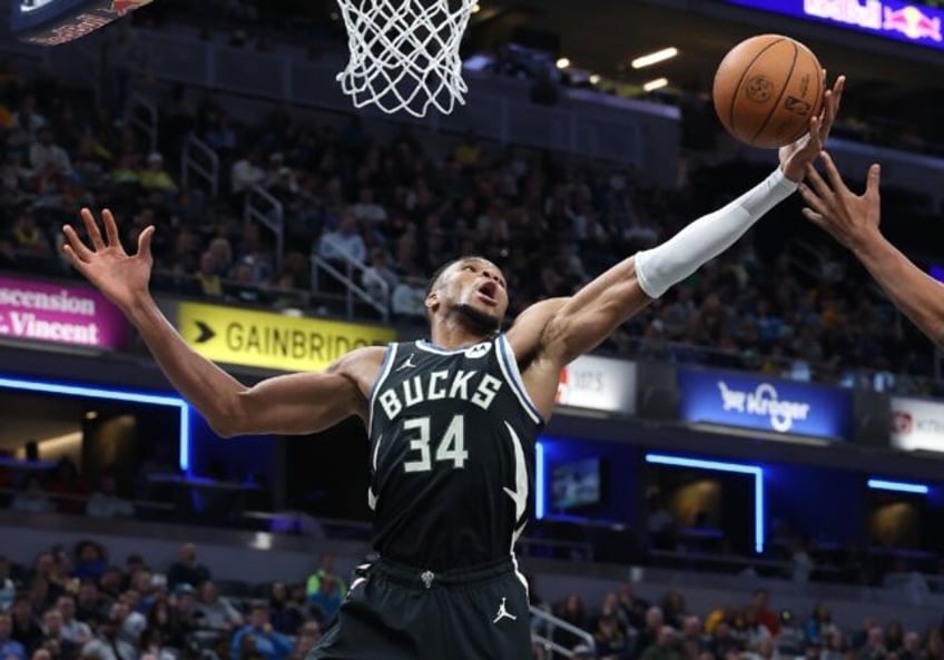 Milwaukee star Giannis Antetokounmpo grabs a rebound in the Bucks' NBA victory over the In