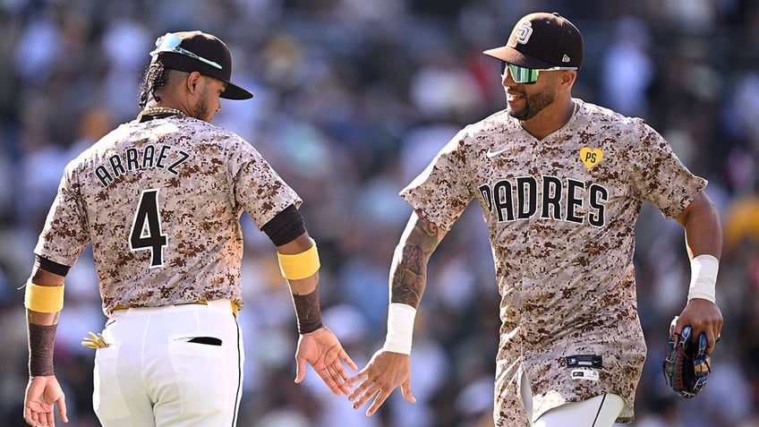 Luis Arraez and David Peralta low five