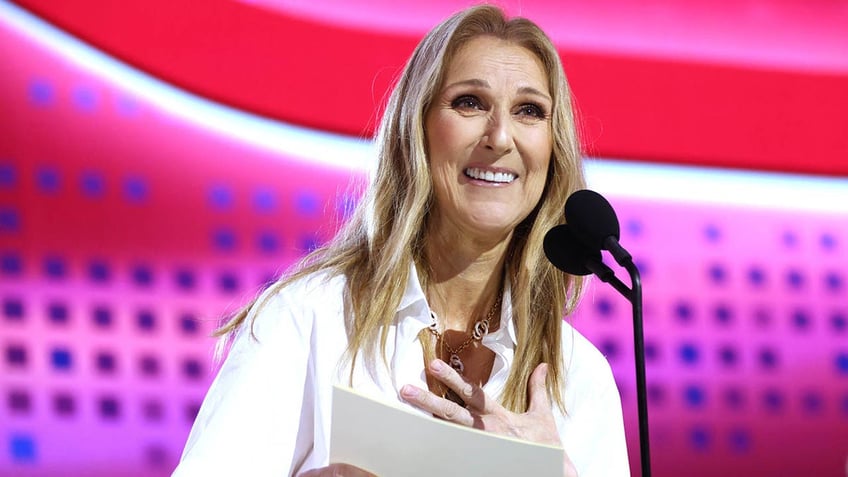 celine dion smiling while announcing draft pick