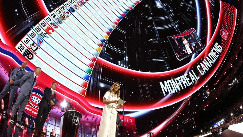 wide shot of celine dion on stage at draft