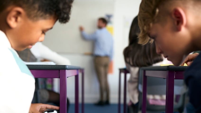 kids in class distracted by phones