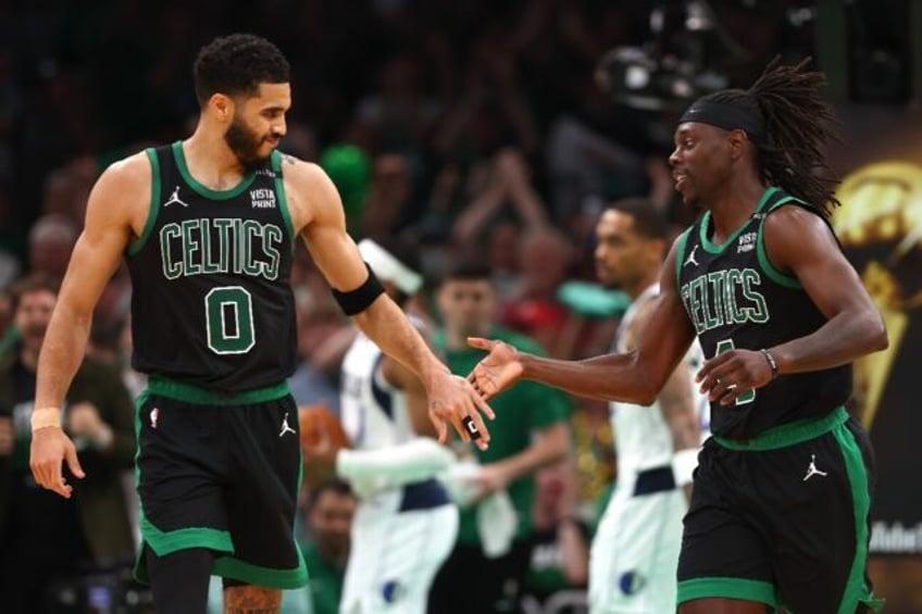 Jayson Tatum and Jrue Holiday of the Boston Celtics high five during the Celtics victory o