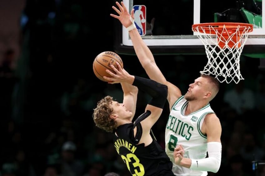 Boston's Kristaps Porzingis defends a shot from Lauri Markkanen in the Celtics' NBA victory over the Utah Jazz