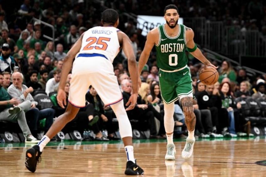 Jayson Tatum (right) turned in a dazzling performance as Boston opened their NBA campaign