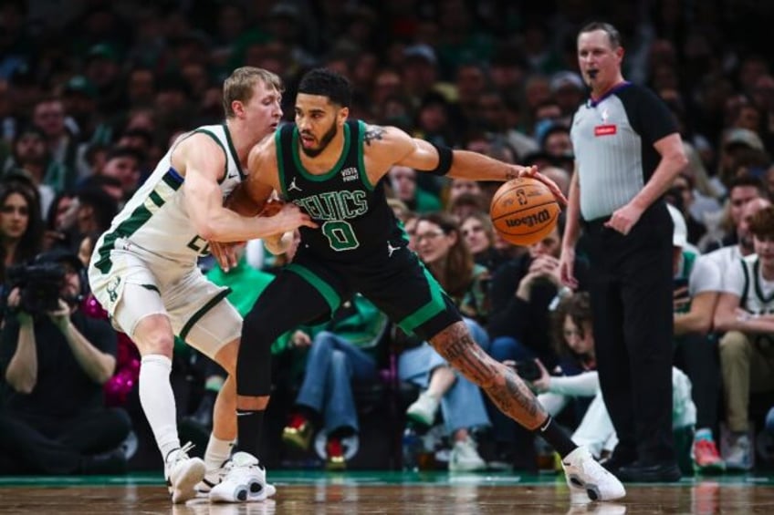 Boston's Jayson Tatum holds off Milwaukee's AJ Green on his way to 31 points in the Celtic