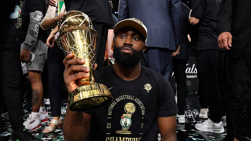 Jaylen Brown holds the trophy