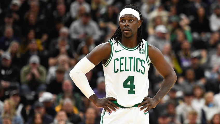 Jrue Holiday stands on a basketball court