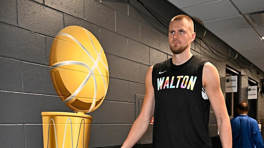 Kristaps Porzingis walks in locker room