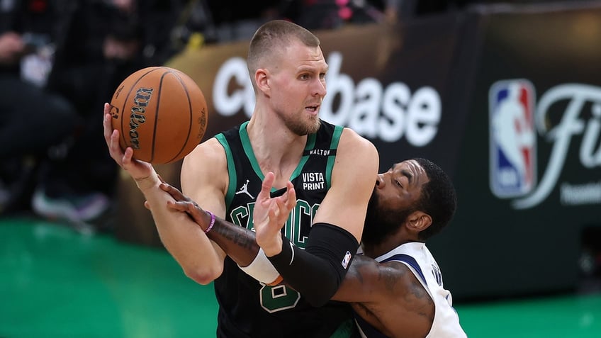 Kristaps Porzingis guarded by Kyrie Irving