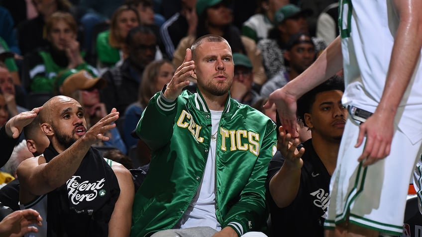 Kristaps Porzingis high-fives teammate