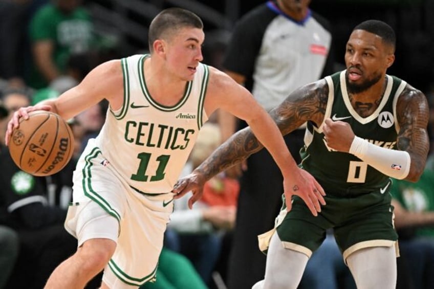 Payton Pritchard drives past Damian Lillard to help Boston defeat the Milwaukee Bucks in t